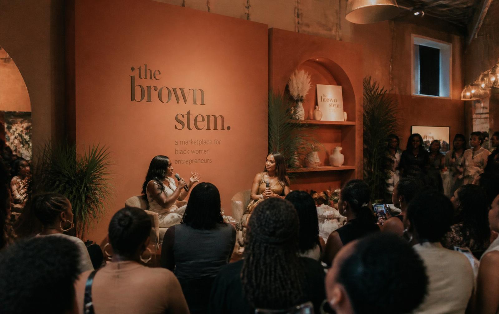 Black women entrepreneurs at a terracotta-lit brand activation panel event